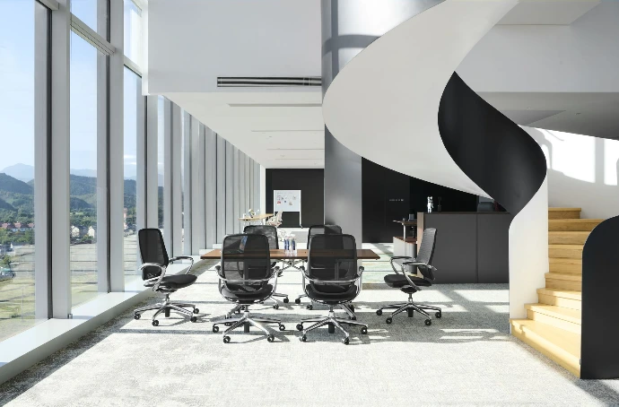 Modern flexible workspace with ergonomic office chairs at hot desking workstations